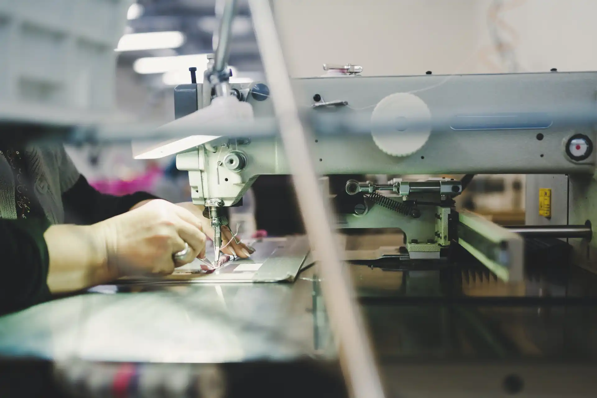 Textile worker operating an industrial sewing machine